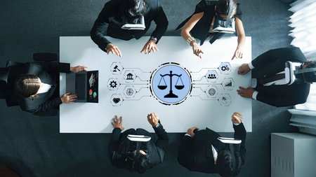 A diverse group of business professionals engages in a virtual reality meeting around a table. The justice symbol in the center represents legal discussions and innovation in a modern workspace.の写真素材