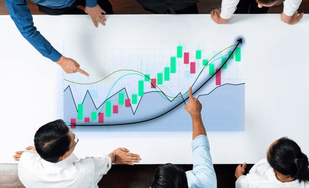 A diverse business team examines a financial growth chart on a large screen, analyzing data trends...