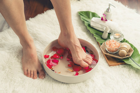 Woman indulges in blissful foot massage at luxurious spa salon while masseur give reflexology therapy in gentle day light ambiance resort or hotel foot spa. Quiescentの写真素材