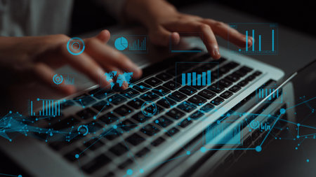 A close-up image of hands typing on a laptop, overlayed with digital data visualizations including...