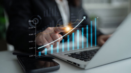 Professional analyzing financial trends using a laptop, focusing on data visualization and growth...