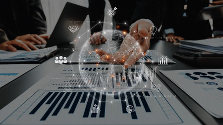 Dynamic business team engaged in data analysis and strategic planning. Digital graphics enhance collaboration, highlighting growth opportunities and insights. Rasterの写真素材