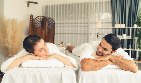 Caucasian couple customer enjoying relaxing anti-stress spa massage and pampering with beauty skin recreation leisure in day light ambient salon spa at luxury resort or hotel. Quiescentの写真素材