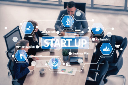 A diverse business team engages in strategic planning for a startup, utilizing digital tools and insights to foster innovation and collaboration in a modern office environment. Tesselの写真素材