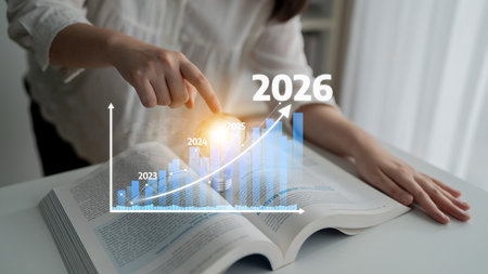 Businessperson examines a financial chart depicting growth trends and future projections for 2026,...