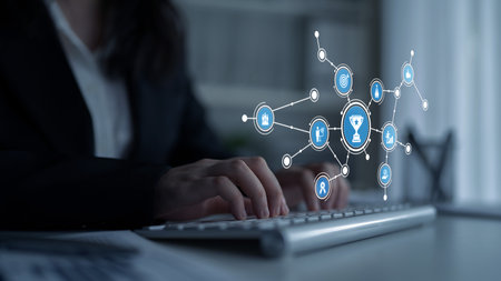 A business professional interacts with a computer, surrounded by digital icons symbolizing achievement and networking, capturing the essence of modern work dynamics.の写真素材