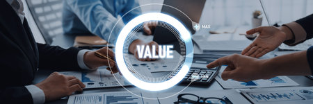 A team of professionals engaged in a business meeting, discussing value creation and financial strategies. Documents, charts, and technology highlight collaboration and decision-making.の写真素材