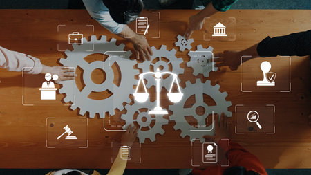 A diverse group works together around a wooden table, using gears and legal symbols to illustrate collaboration in law and business innovation, emphasizing teamwork. Rasterの写真素材