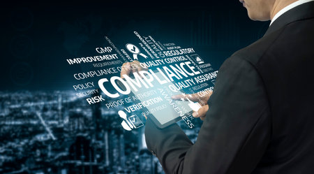 A business professional engages with compliance concepts using a digital tablet, set against a vibrant city backdrop, emphasizing quality control and risk management strategies.の写真素材