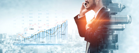 Business professional engaged on smartphone with a financial graph, highlighting communication, success, and innovation in a modern corporate environment.の写真素材