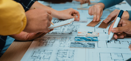 A vibrant scene showing diverse hands engaged in a collaborative design session involving sketches,...
