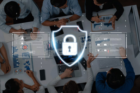 A diverse group of professionals collaborates around a table, focused on cybersecurity strategies,...