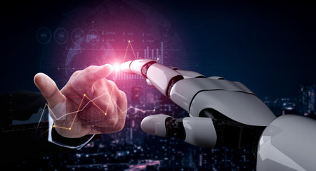 A close-up of a human hand and a robotic hand reaching toward each other, symbolizing connection in a modern business environment, with data analytics visualized in the background.の写真素材