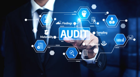 A businessman in a suit interacts with a digital screen featuring audit icons, symbolizing data analysis and compliance in corporate finance and management. Tesselの写真素材