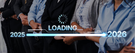 A group of business professionals stand united as a symbolic loading bar highlights growth and transition, representing the journey from 2025 to 2026 in a corporate atmosphere. Tropeの写真素材