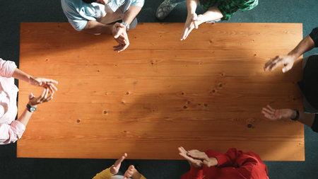 Close up of happy start up business people hand putting hands together at meeting and clapping hand to celebrate collaboration and increasing sales or encourage teamwork and togetherness. Convocation.の写真素材