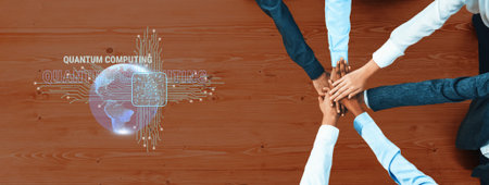 Diverse hands join in unity on a table, symbolizing teamwork in quantum computing, surrounded by...
