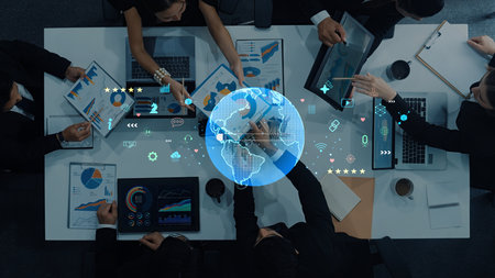 A diverse business team engages in collaborative data analysis and strategy development, utilizing...
