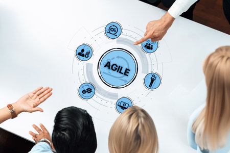 A diverse group of professionals engaged in a collaborative discussion around a table, focusing on agile methodology as a visual representation of dynamic teamwork and effective strategy.の写真素材