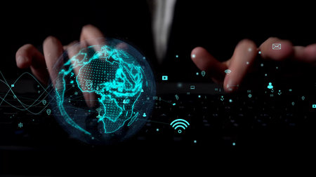 A close-up view of hands typing on a keyboard in a dark setting, enhanced by a digital globe graphic...