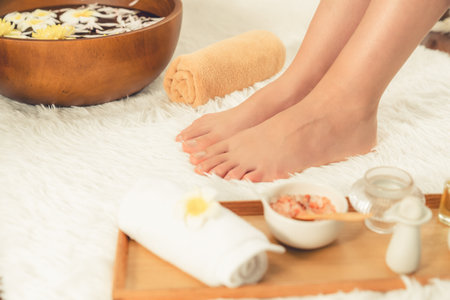 Panorama top view woman indulges in blissful foot massage at luxurious spa salon while masseur give reflexology therapy in gentle day light ambiance resort or hotel foot spa. Quiescentの写真素材