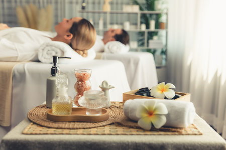 Aromatherapy massage on daylight ambiance or spa salon composition setup with focus decor and spa accessories on blur woman enjoying blissful aroma spa massage in resort or hotel background. Quiescentの写真素材