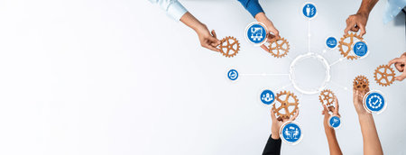 Hands unite around gears symbolizing collaboration and strategic management in a corporate setting, illustrating the importance of teamwork for business success.の写真素材