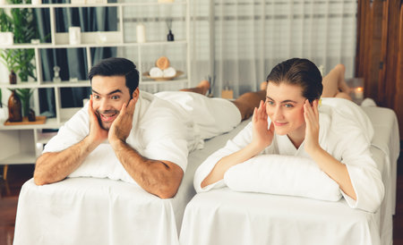 Caucasian couple customer enjoying relaxing anti-stress spa massage and pampering with beauty skin recreation leisure in day light ambient salon spa at luxury resort or hotel. Quiescentの写真素材