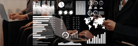 A group of professionals engages in a meeting utilizing data analytics and visualization tools. The...