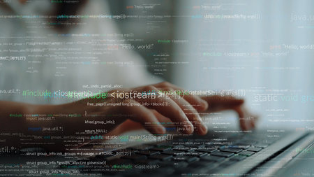 Close-up view of hands typing on a laptop keyboard, with a digital code overlay symbolizing software development and programming in a modern workspace.の写真素材