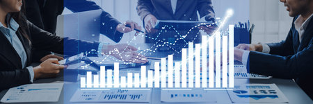 A dynamic business team collaborates on a financial report, showcasing charts and graphs in a modern...