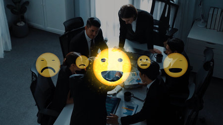 A diverse team collaborates during a business meeting, showcasing various emojis to express...