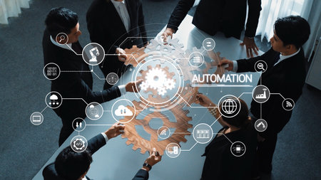 A diverse team collaborates on automation strategies, featuring digital interfaces and gear symbols that represent innovation and modern business solutions in a professional setting. Rasterの写真素材