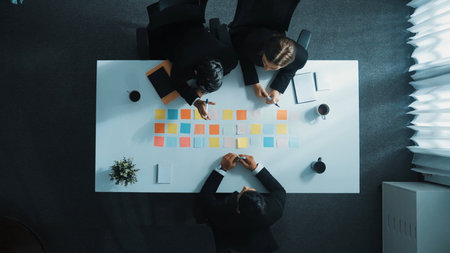 Smart business man holding coffee mug and placed on meeting table while sitting at table with sticky notes placed. Skilled business people starting discussion and sharing marketing idea. Directorate.の写真素材