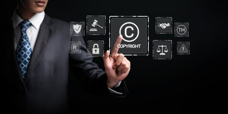 A businessman interacts with digital copyright symbols and legal icons, emphasizing the importance of online copyright regulation and intellectual property in today digital age. XDMCPの写真素材
