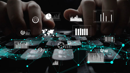 Close-up view of hands typing on a keyboard surrounded by vivid graphics representing data analytics, charts, and business insights in a modern digital workspace.の写真素材