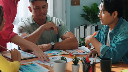 Top view of business people working together to choosing color from color palette. Project manager present idea by using tablet to marketing team while business man looking at logo graphic. Symposium.の写真素材