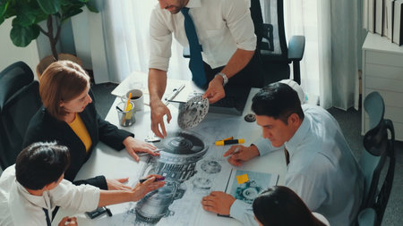 Group of diverse team planning strategy while sitting at table with project plan. Top aerial view of smart business people working together to brainstorm and design house construction.の写真素材