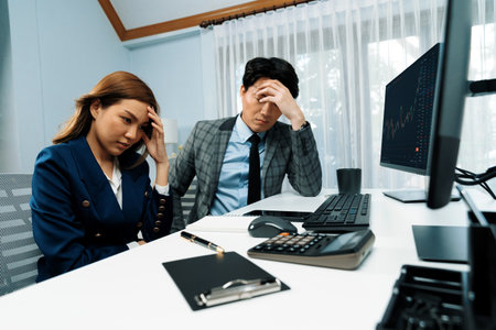 Stressful exchange investing business partners discussing in loss profit stock exchange rate investment missing trade value dynamic complication on financial application in recession stage. Infobahn.の写真素材