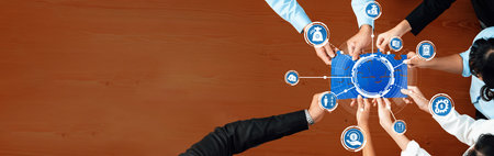 A diverse team collaborates over a wooden table, analyzing various business strategies represented...