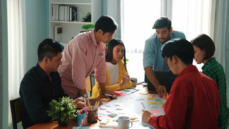 Top view of diverse business people drawing mind map by using marker while brainstorm idea and...