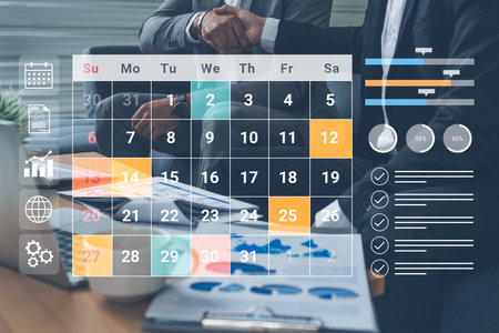 A professional setting showcasing a calendar and business documents on a desk, highlighting partnership and strategic planning through data analysis and teamwork.の写真素材