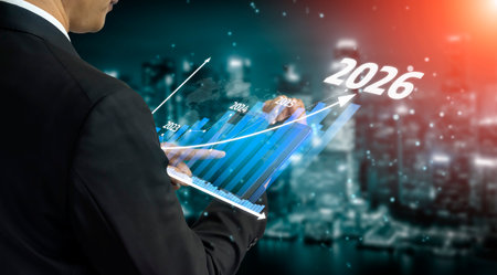 A businessman engages with digital graphs on a device, illustrating projected growth and financial...