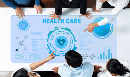 Teams collaborate over health care data displayed on a modern digital interface, showcasing innovative technology and insights in a professional office environment.の写真素材