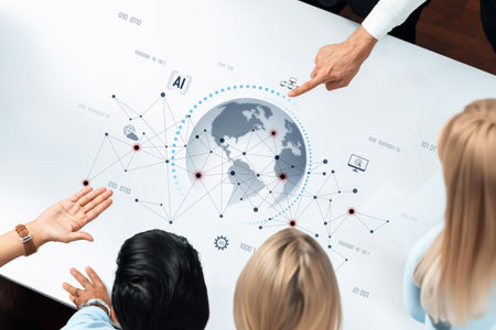 A team of professionals collaborates over a modern table, analyzing global data visualizations and exploring trends in artificial intelligence and technology.の写真素材