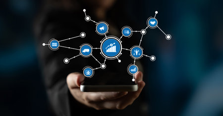 A person holds a smartphone displaying various icons that symbolize data analysis and growth in a...