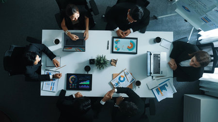 Top view of executive manager present growth graph while smart team clap hands and shale hand with...