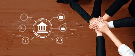 Hands of diverse professionals united on a wooden table, symbolizing business teamwork for finance and technology. Digital icons highlight collaboration and innovation.の写真素材