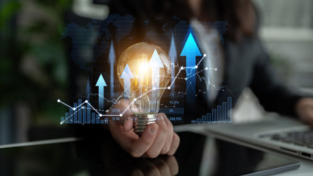 Captivating business innovation image featuring a light bulb, rising graphs, and data visualization, symbolizing growth, creativity, and strategic planning in a corporate setting.の写真素材