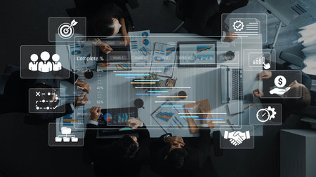 A group of professionals collaborates during a business meeting, analyzing data and discussing strategies while using modern technology and visual aids on a conference table. Rasterの写真素材